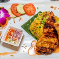 Khao Mok Gai · Grilled marinated chicken breast top with peanut sauce, curry rice, and served with cucumber...