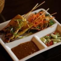 Chicken Satay · Served with peanut sauce and cucumber salad.