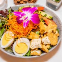 Thai Salad · Mixed green salads, tofu, egg, cucumbers, and tomatoes with peanut dressing.