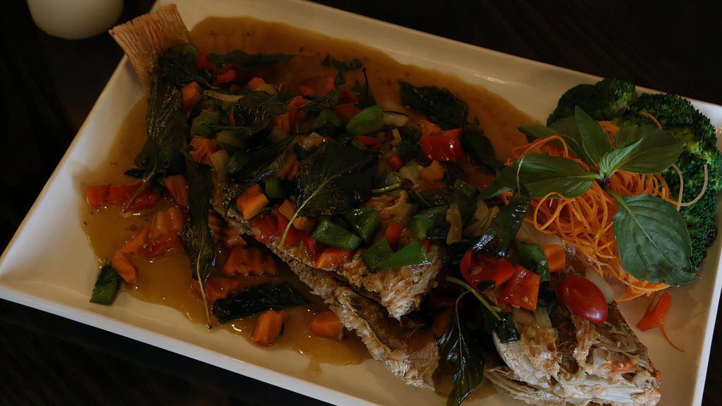 Pla Ka Prow · Spicy. Crispy golden fish topped with chili, string beans, onion, and basil leaves in basil sauce.