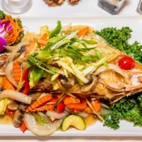 Pla Ginger · Crispy golden fish topped with fresh ginger, mushrooms, onion, and bell peppers in ginger sa...