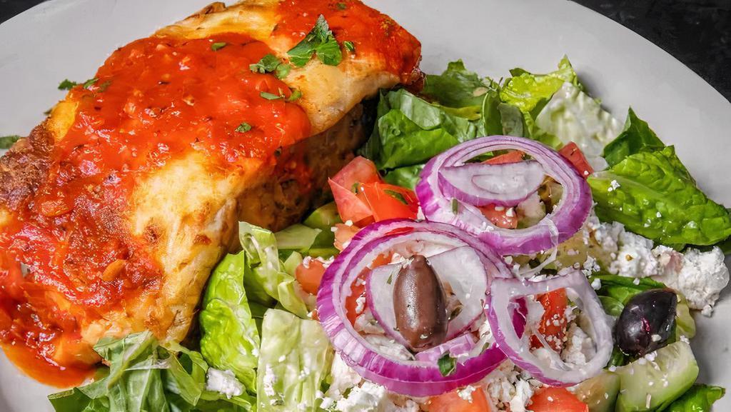 Mousaka · Traditional Greek casserole made with layers of  eggplant slices, potato, seasoned ground beef covered in a thick layer of bechamel sauce. Served with small salad and pita on the side. Served with small salad and side of pita bread.