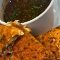 Birria Quesadilla · MELTED CHIHUAHUA CHEESE ON AN ORIGINAL TORTILLA BIRRIA, CILANTRO AND ONIONS . HOT SAUCE ON S...