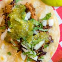 Carnitas Taco · Tequila and Lime Marinade Pulled Pork, Cilantro, Pickled Red Onion, Refried beans & Carrot S...
