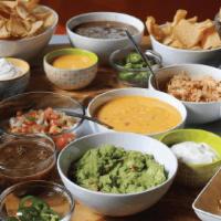 Nacho Appetizer Bar For 4 · Build your own nachos with 2 full pounds of homemade chips plus all the salsa, queso, guacam...