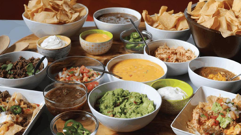 Nacho Appetizer Bar For 4 · Build your own nachos with 2 full pounds of homemade chips plus all the salsa, queso, guacamole, sour cream, pico de gallo, fresh and pickled jalapenos, beans, sauteed chicken and ground beef you’ll need to serve 4-6 people.