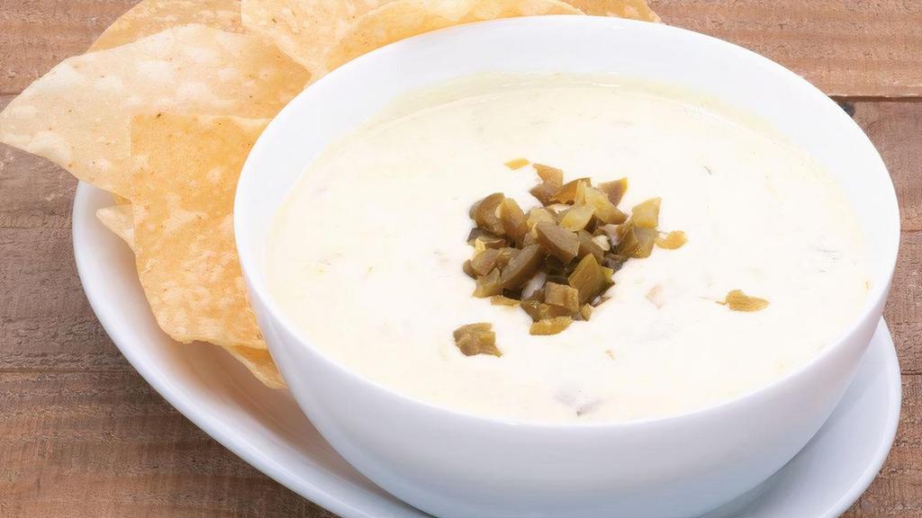 Queso Blanco · Rich white queso with New Mexico hatch green chiles and jalapeño peppers.