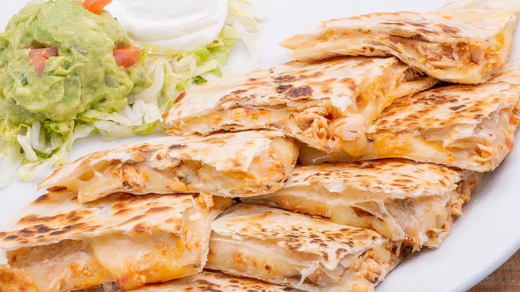 Pulled Chicken Quesadilla · Sautéed pulled chicken, tomatoes, onions, and Monterey Jack on flour tortillas with sour cream and fresh guacamole.
