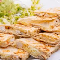 Fajita Quesadilla · Steak or Chicken Fajita, sautéed onions and Monterrey jack on flour tortillas with sour crea...