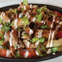Carnitas Fajitas For Two · Savory braised pork topped with honey chipotle glaze, fresh crema and cilantro.  Served with...