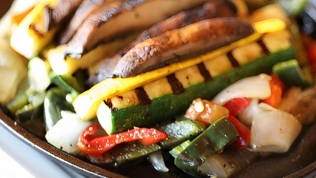 Grilled Vegetable Fajitas For One · Mesquite grilled vegetables including zucchini, yellow squash, portobello mushrooms, sautéed peppers, and onions. Served with fresh guacamole, sour cream, cheese, with our homemade flour tortillas, cilantro white rice and black beans.