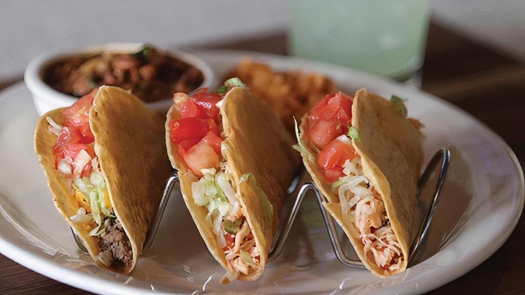Crispy Taco Plate · Choose between two or three pulled chicken or ground beef tacos with lettuce, tomato, and shredded cheese.  Served with Mexican rice and frijoles a la charra.