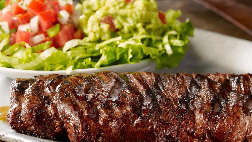 Carne Asada · Hand-cut marinated 21-day aged skirt steak*. Served with homemade guacamole, pico de gallo, Mexican rice and frijoles a la charra