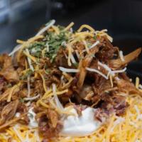 Famous Outlaw Potato · Butter, cheese, sour cream, bacon, chives and a heaping pile of meat on top - your pick. Pul...