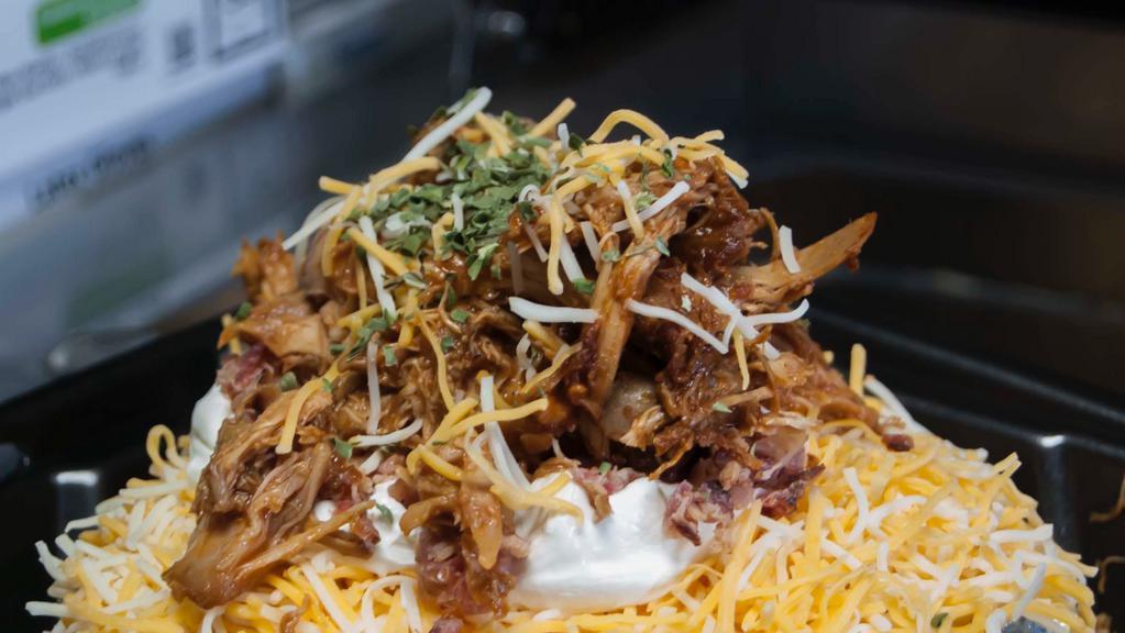 Famous Outlaw Potato · Butter, cheese, sour cream, bacon, chives and a heaping pile of meat on top - your pick. Pulled pork, BBQ beef or BBQ chicken.