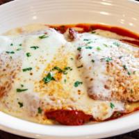 Veal Parmigiana · Pan-fried breaded tender veal cutlets topped with classic tomato sauce and melted mozzarella.