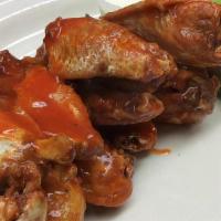 Chicken Wings · Tossed with sauce.