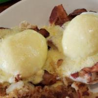 American Eggs Benedict · Poached Eggs on an English Muffin, topped with
Grilled Tomatoes, Portabella Mushrooms &
Holl...