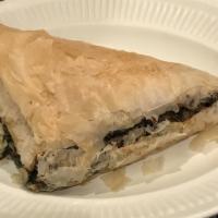 Spanakopita · Spinach pie. Spinach, feta, herbs, and spices wrapped in light layers of filo.