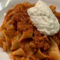 Pappardelle Bolognese · Housemade Pappardelle, beef pork and veal meat sauce, scoop of imported ricotta.