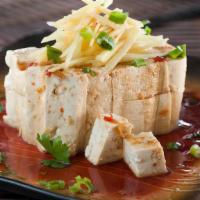 Cold Tofu · Refreshing tofu blocks served with a light ginger soy chili sauce. Topped with ginger, green...