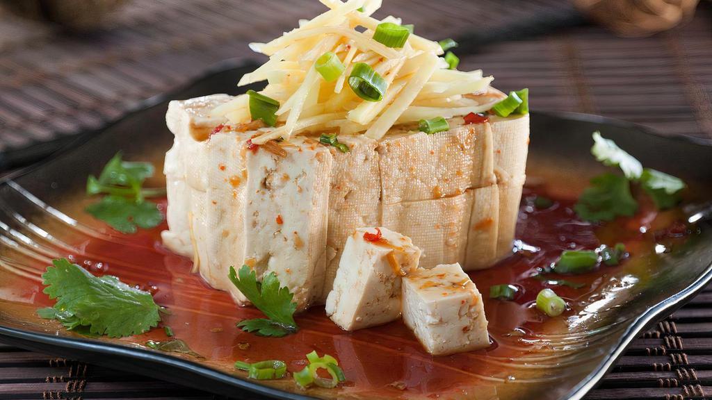 Cold Tofu · Refreshing tofu blocks served with a light ginger soy chili sauce. Topped with ginger, green onions and cilantro.