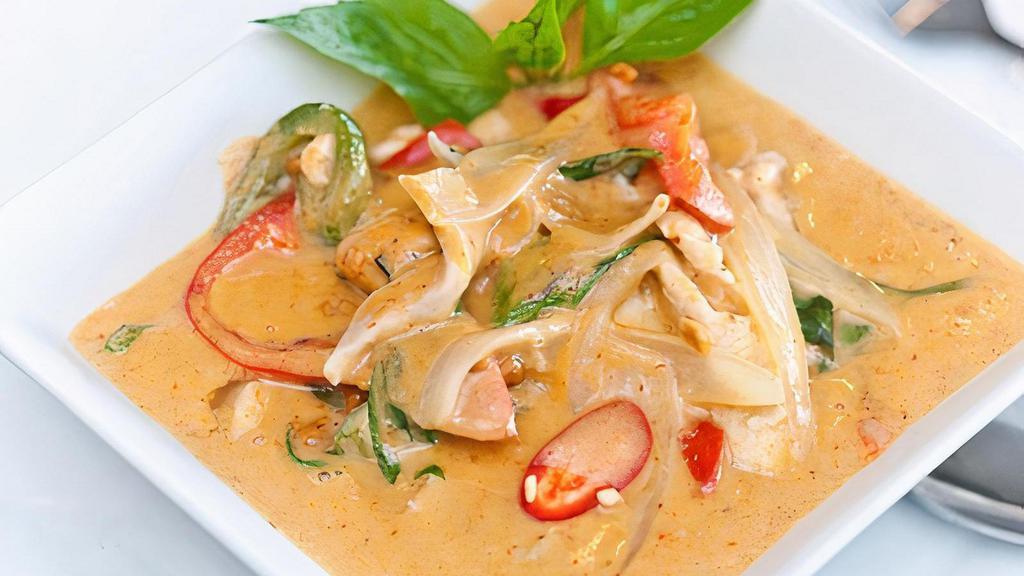 Panang Curry (Gluten Free) · Thick red curry, coconut milk, bell peppers, onions and basil topped with peanut sauce.