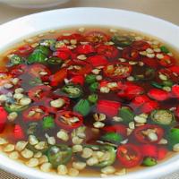 Side Prik Nam Pla Sauce · Fish sauce with fresh Thai chili and vinegar. 2 oz portion. Add to any dish for your desired...