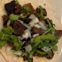 Carne Asada Taco · Beef, Corn Tortilla, Guacamole, Cilantro, Onion, Side Of Radish, And Lime