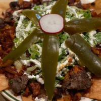 Nachos Texanos (Texano Style Nachos) · Chorizo and steak texano style nachos. black beans, lettuce, tomato, jalapenos, mustard chee...