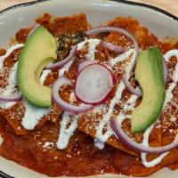 Chilaquiles · Casserole tortilla, onions, sour cream, cotija cheese, and avocado