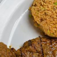 Moro De Lenteja · Lentils rice served with beef or chicken breast fillet and salad.