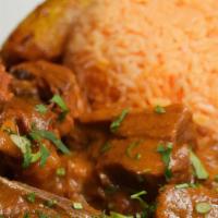Seco De Chivo · Goat stew with rice and sweet plantains.