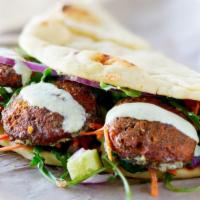 Falafel Pita · Falafel with lettuce, tomatoes, cucumber, hot and white sauce.