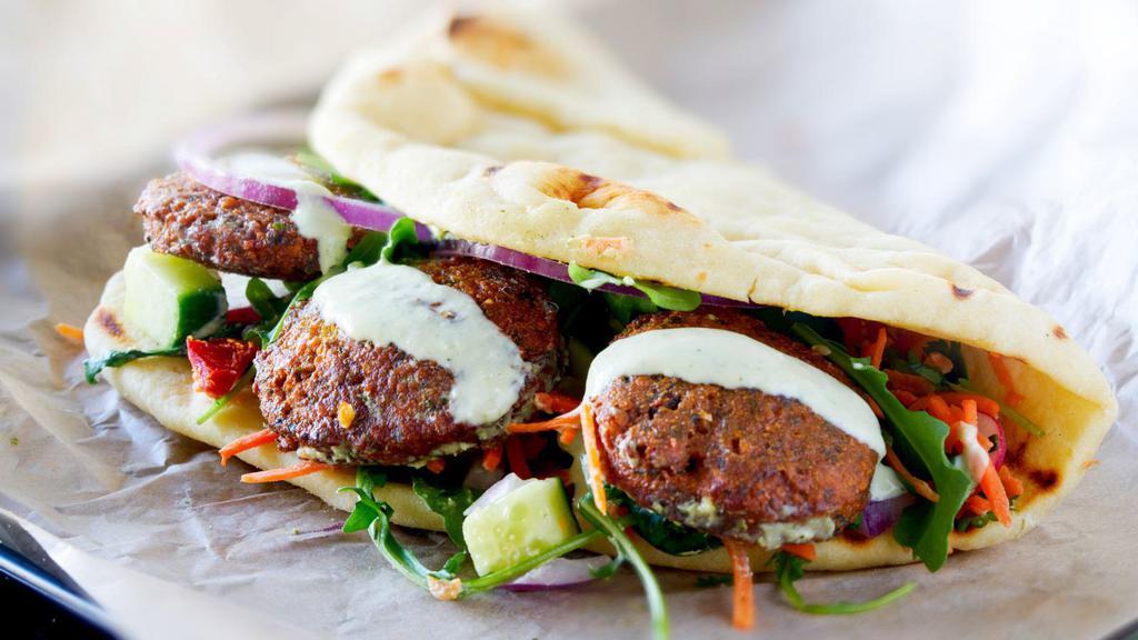 Falafel Wrap · Falafel with lettuce, tomatoes, cucumber, hot and white sauce.