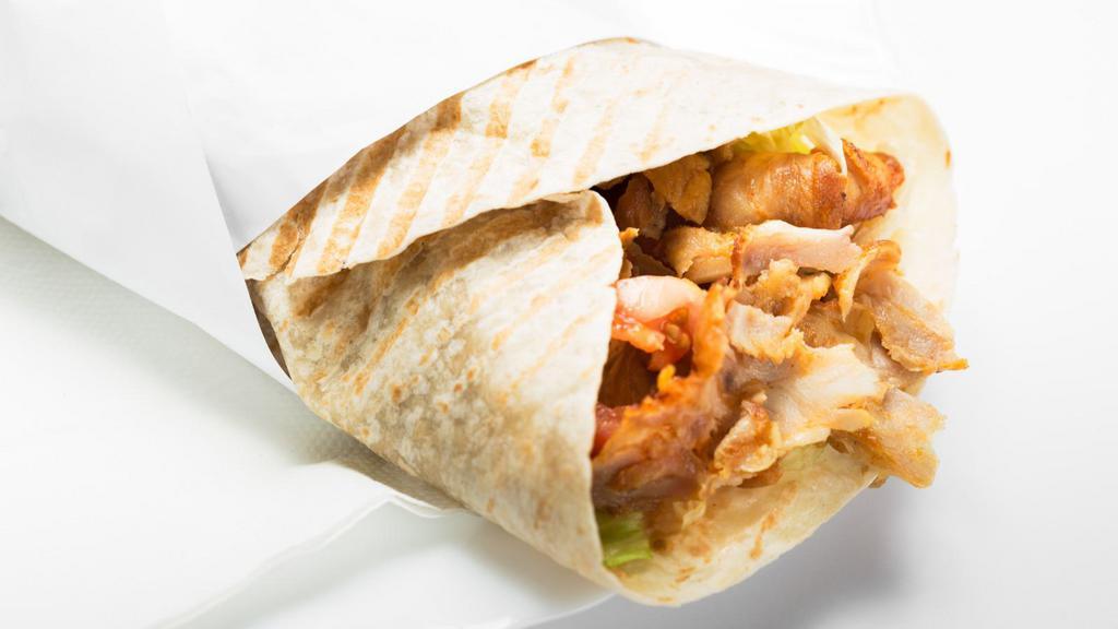 Chicken Shawarma Wrap · Chicken shawarma with pickles, garlic sauce, lettuce, and tomatoes.