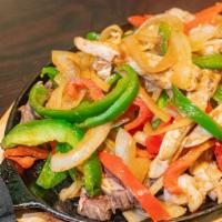 Fajitas · Our signature marinated sauteed green peppers and onions served with side rice, beans and to...