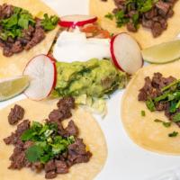 Tacos · Traditionally made with corn tortillas cilantro with your choice of meat.