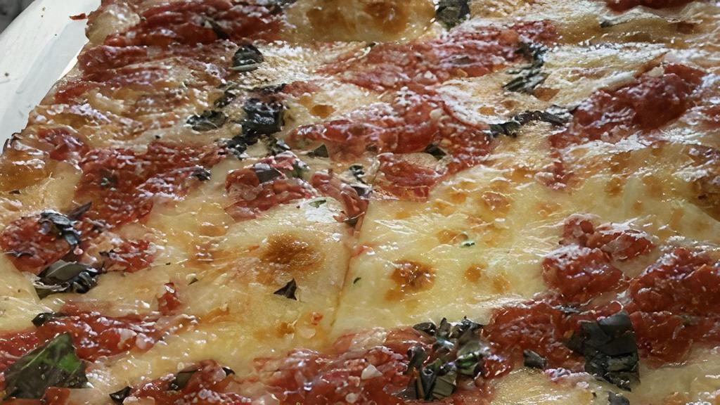 Thin Crust Sicilian Grandma Pizza · Thin crust with mozzarella, sweet garlic, plum tomato, basil and Romano.