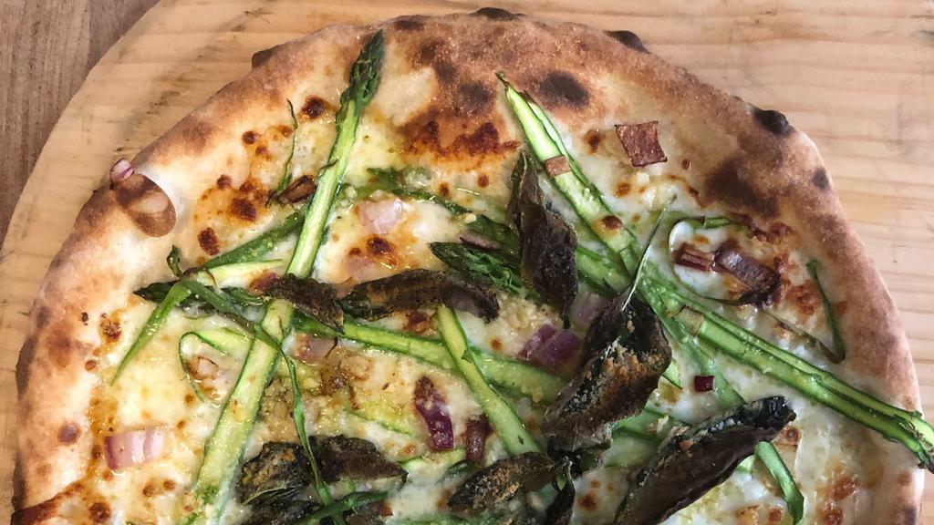 Spring Asparagus Pizza · Local Asparagus, pork pancetta, fresh garlic, aged mozzarella, lemon, Parmesan, roasted red onion,  and Martha’s Vineyard sea salt.