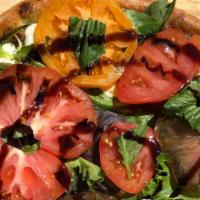 Heirloom Caprese Pizza · Fresh raw organic heirloom tomatoes from Shushan Valley Hydro Farm over roasted basil walnut...