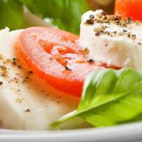 Caprese Salad · With  mozzarella, tomatoes, roasted peppers, lettuce, dressing.