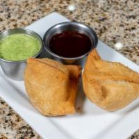 Vegetable Samosa (2 Pieces) · Fried pastry with savory filling, such as spiced potato, onions and peas.