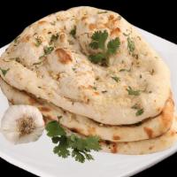 Garlic Naan · Leavened soft wheat bread with garlic and cilantro. Baked fresh to order in our clay tandoor...