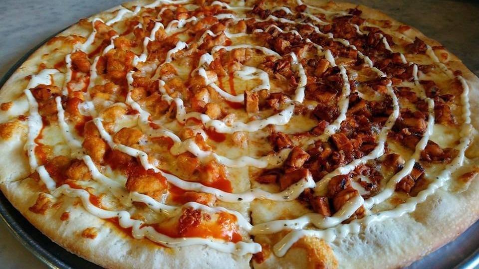 Buffalo Chicken Pizza · Breaded buffalo chicken, topped with mozzarella, and drizzled with swirls of our buffalo sauce and ranch dressing.
