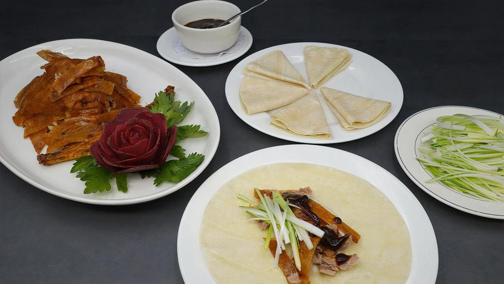Peking Duck 北京烤鸭 · Crispy skin and tender duck meat served with plum sauce and scallions wrapped in steamed crepes.. with 6 pancakes.