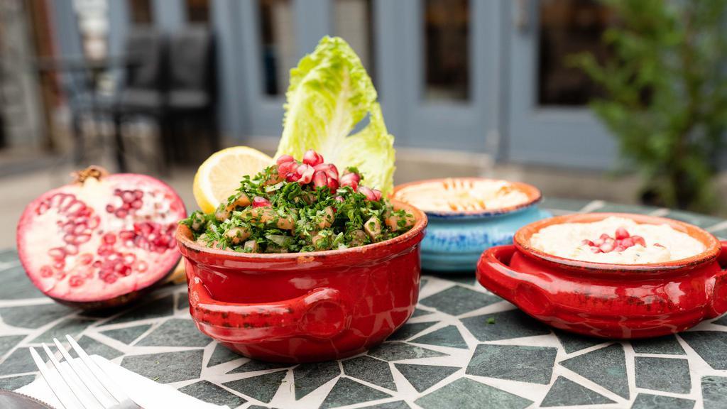 Tabbouleh · Fresh parsley, tomatoes, cracked wheat, onions, freshly squeezed lemon juice and virgin olive oil.
