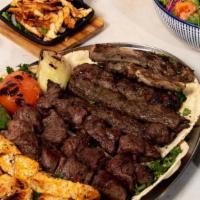 Family Mixed Grill · Serves 6 people. This family platter includes 4 kafta skewers, 4 chicken kebab skewers, 4 fi...