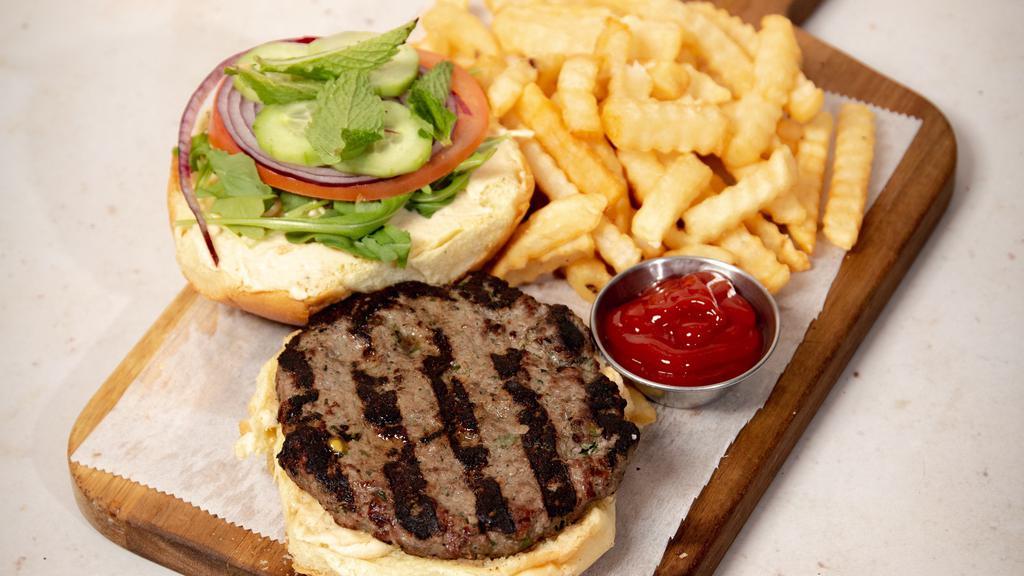 Lebanese Burger · Our special Lebanese homemade burger comes with hummus, fresh mint, tomato, onion, cucumber and arugula with pomegranate dressing. Served with French fries.