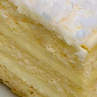 Coconut Cake · Moist vanilla cake made with fresh grated coconut, layered with crème fraiche pastry cream, ...